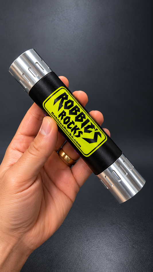 Hand holding the Robbie's Rocks UV mineral light to show its handheld size, neon yellow label on a black body between silver aluminum end caps.